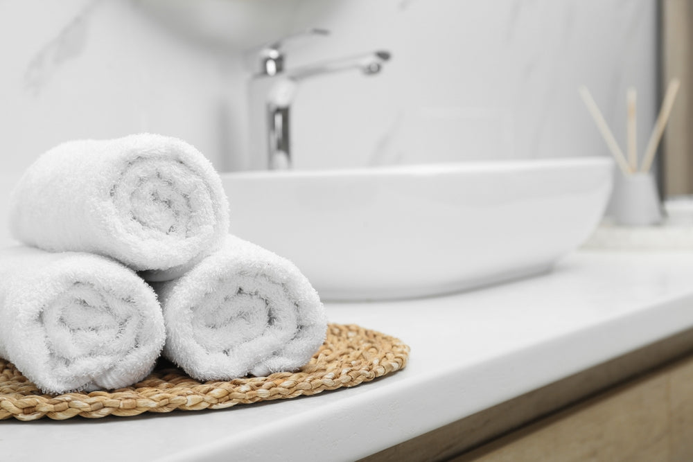 A collection of soft hand towels and face cloths for hotels