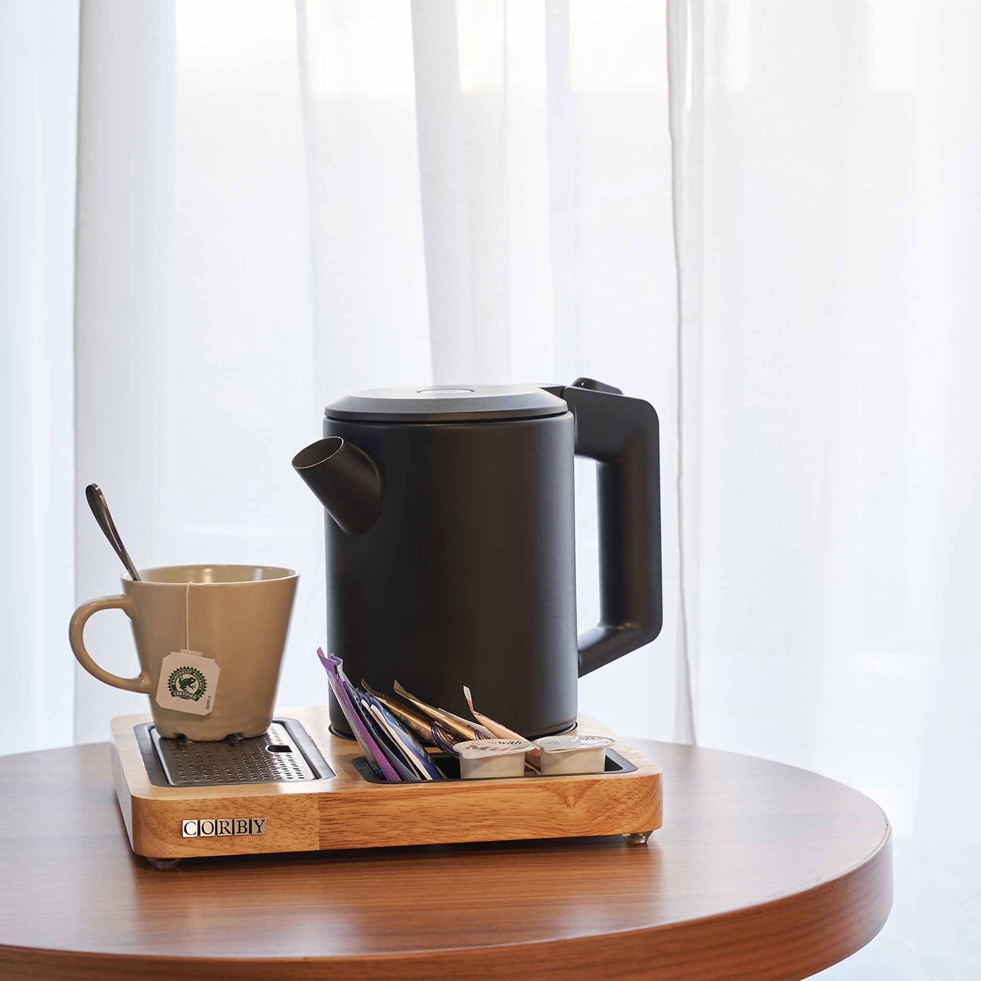 Corby canterbury compact welcome tray with black Canterbury kettle and mugs on side table