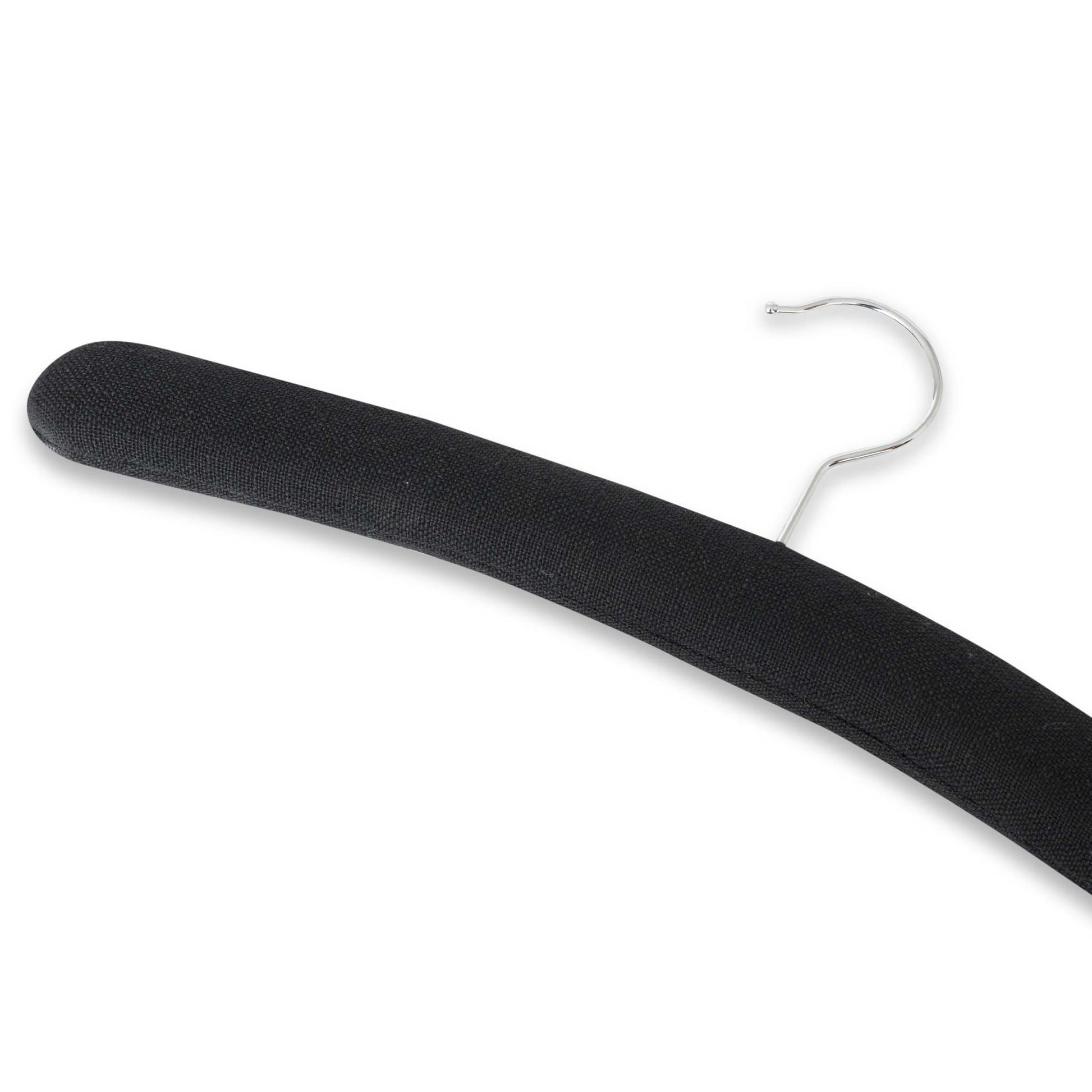 Close-up angled detail of Bentley Wellington black padded cotton hotel hanger with curved design and chrome hook