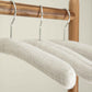 Close-up of Bentley Wellington natural cotton padded hotel hangers on wooden rail, showing texture and soft curved design