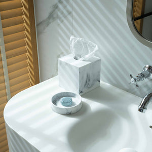 Lifestyle image of white marble Baker tissue box cover in hotel bathroom