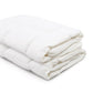 A folded white mattress topper on a clean white background.