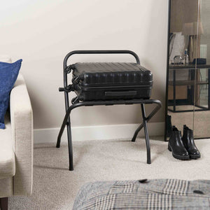 Corby Ashton matte black metal luggage rack with backrest holding suitcase in modern hotel guest room