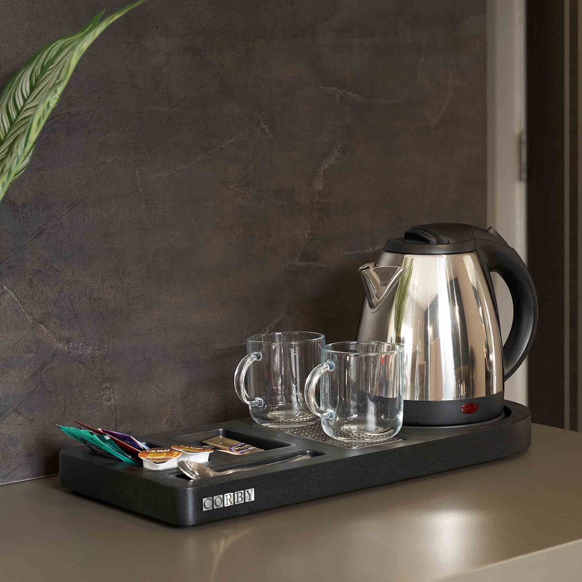 Corby Buckingham chrome hospitality kettle with mugs and beverage tray set up on hotel guest room refreshment station