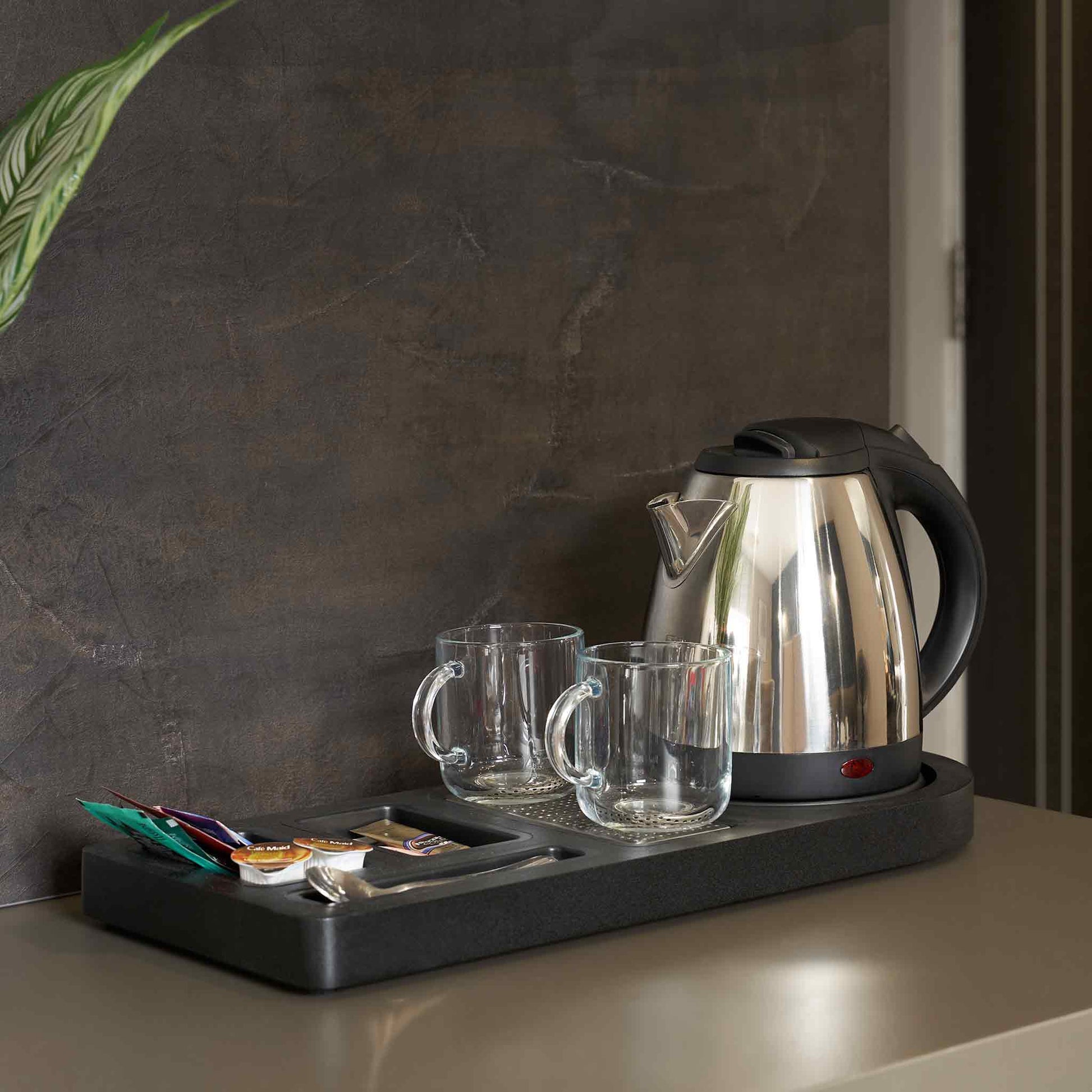 Corby Buckingham chrome hospitality kettle with mugs and beverage tray set up on hotel guest room refreshment station
