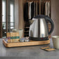Corby Buckingham chrome hotel kettle on wooden hospitality tray with mugs, stirrer, and hot drink sachets in guest room setting