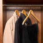 Corby Burlington light wood guest hangers with chrome hooks holding guest clothing in hotel wardrobe