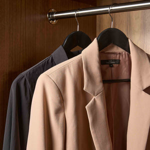 Corby Chelsea black wooden wishbone guest hangers with chrome hooks holding jacket and shirt in hotel wardrobe