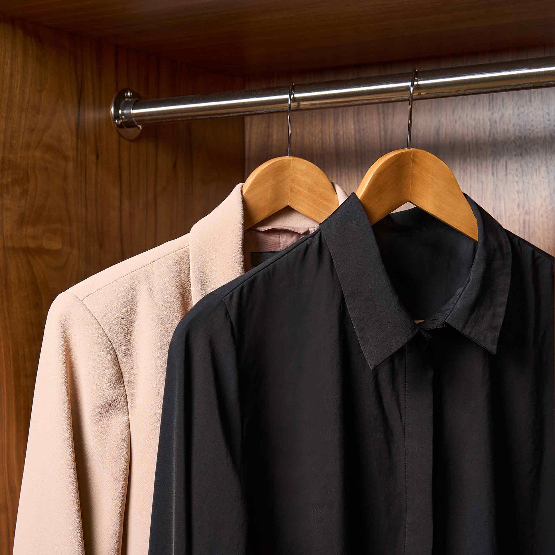 Corby Chelsea light wood wishbone guest hangers with chrome hooks holding shirts in hotel wardrobe