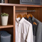 Corby Chelsea light wood guest hangers with chrome hooks holding white shirt and suit jacket in hotel wardrobe