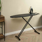Corby Classic dark grey ironing board with iron rest shown in guest room setting with steam iron