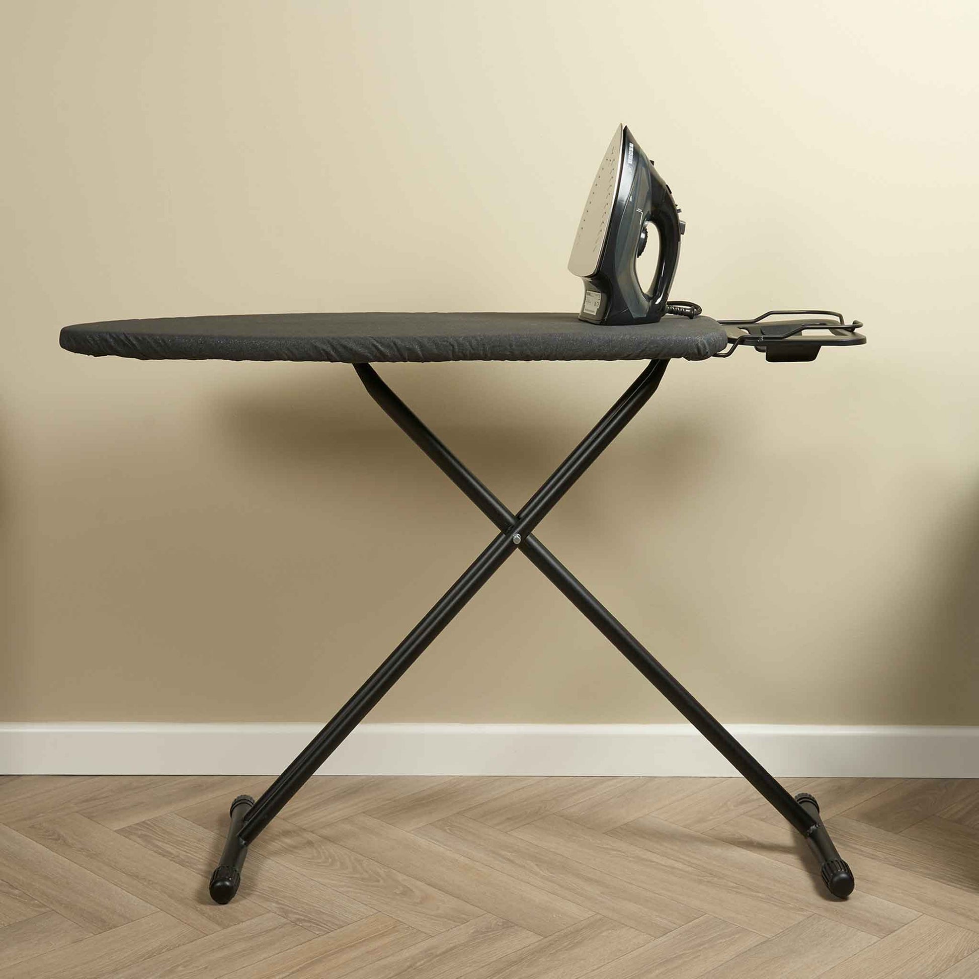Corby Classic Ironing Board in dark grey with iron rest, set up in guest room for hotel use