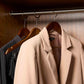 Corby Clifford dark wood hotel hangers with chrome hooks holding guest jacket and clothing in fitted wardrobe