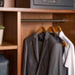 Corby Clifford light wood hotel hangers with chrome hooks displaying guest suit and shirt in fitted wardrobe with safe