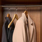 Corby Clifford light wood hotel hangers with chrome hooks holding guest jacket and clothing in luxury wardrobe setting