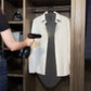 Lady using garment steamer on darlington mat on clothes rail