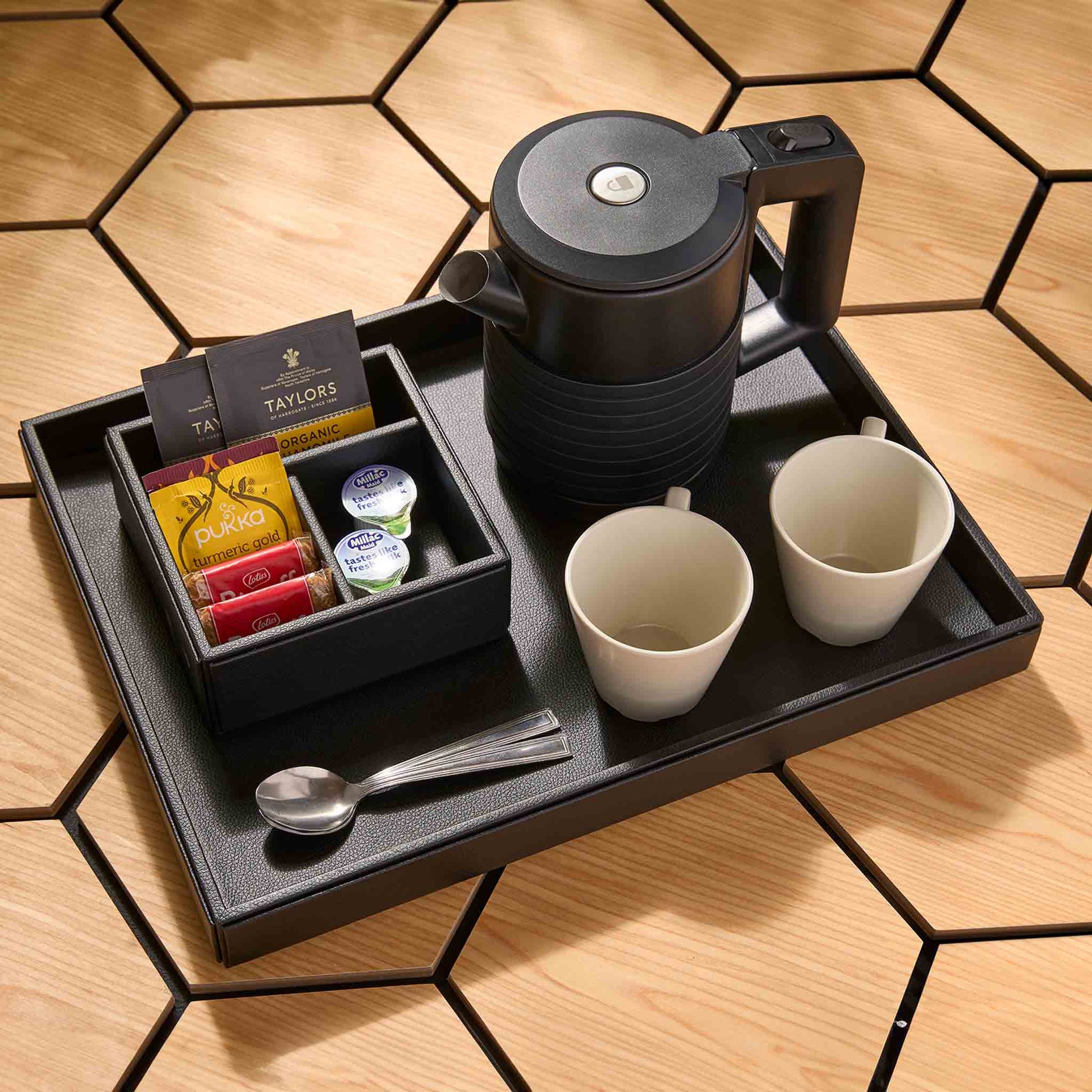 Corby Canterbury 0.6 litre black double-walled hotel kettle on hospitality tray with mugs, teaspoons and complimentary tea and coffee