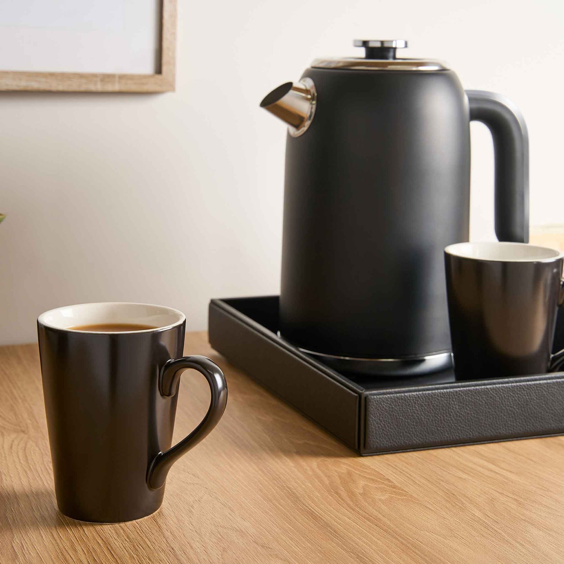 Corby Fenton black ceramic mugs on wooden hotel room surface with kettle set, ideal for hospitality beverage trays