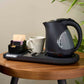 Corby Lancaster 1L black kettle with hospitality welcome tray, white ceramic mug, and tea sachets on hotel room table