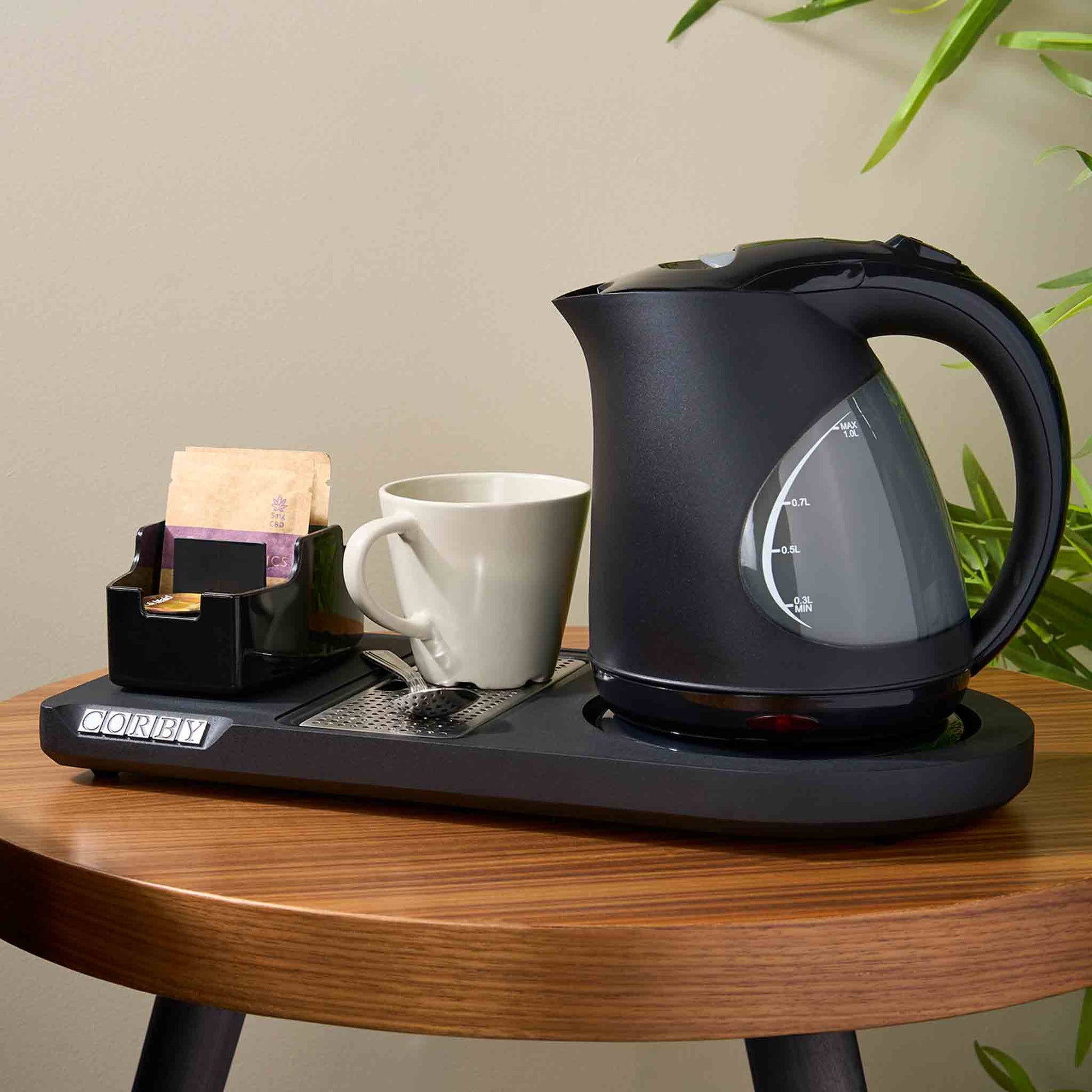 Corby Lancaster 1L black kettle with hospitality welcome tray, white ceramic mug, and tea sachets on hotel room table