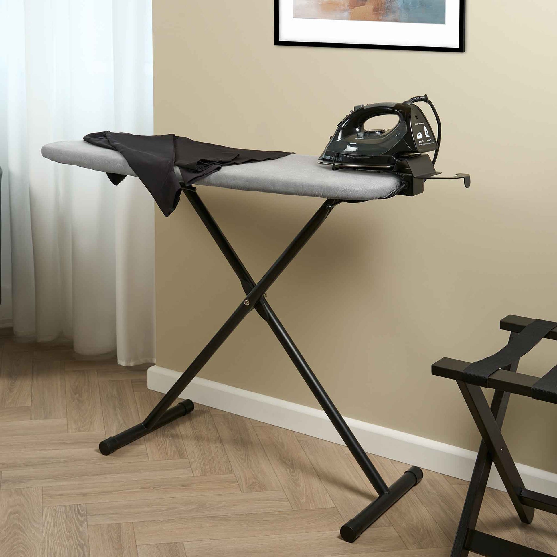Corby Oxford Premium Ironing Centre with 2000W steam iron and shirt in modern hotel room with luggage rack and wood flooring