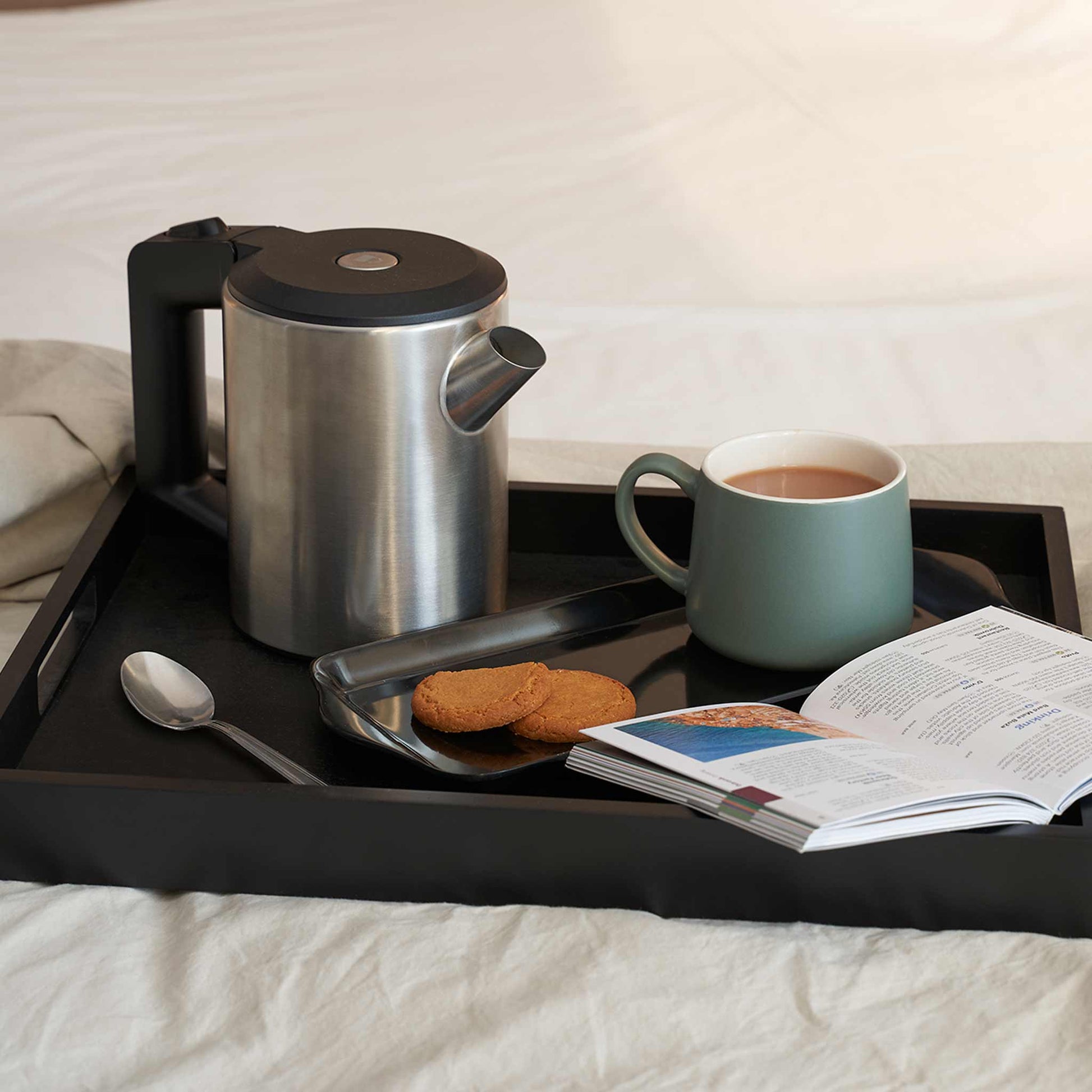 Black wooden butler tray with coffee and biscuits