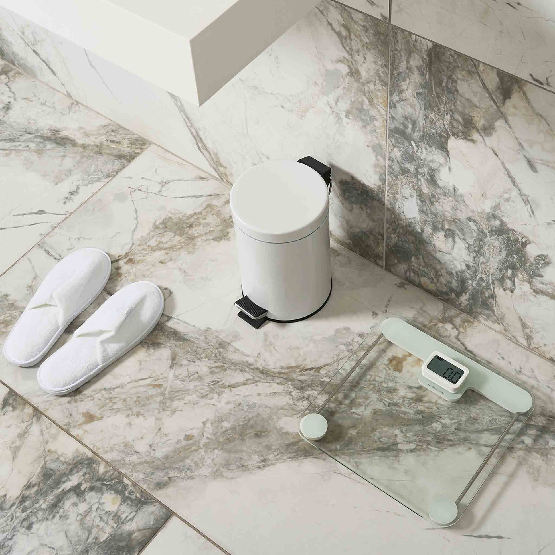 Corby Sandwell battery-free digital bathroom scales with LCD display in hotel bathroom alongside white pedal bin and guest slippers