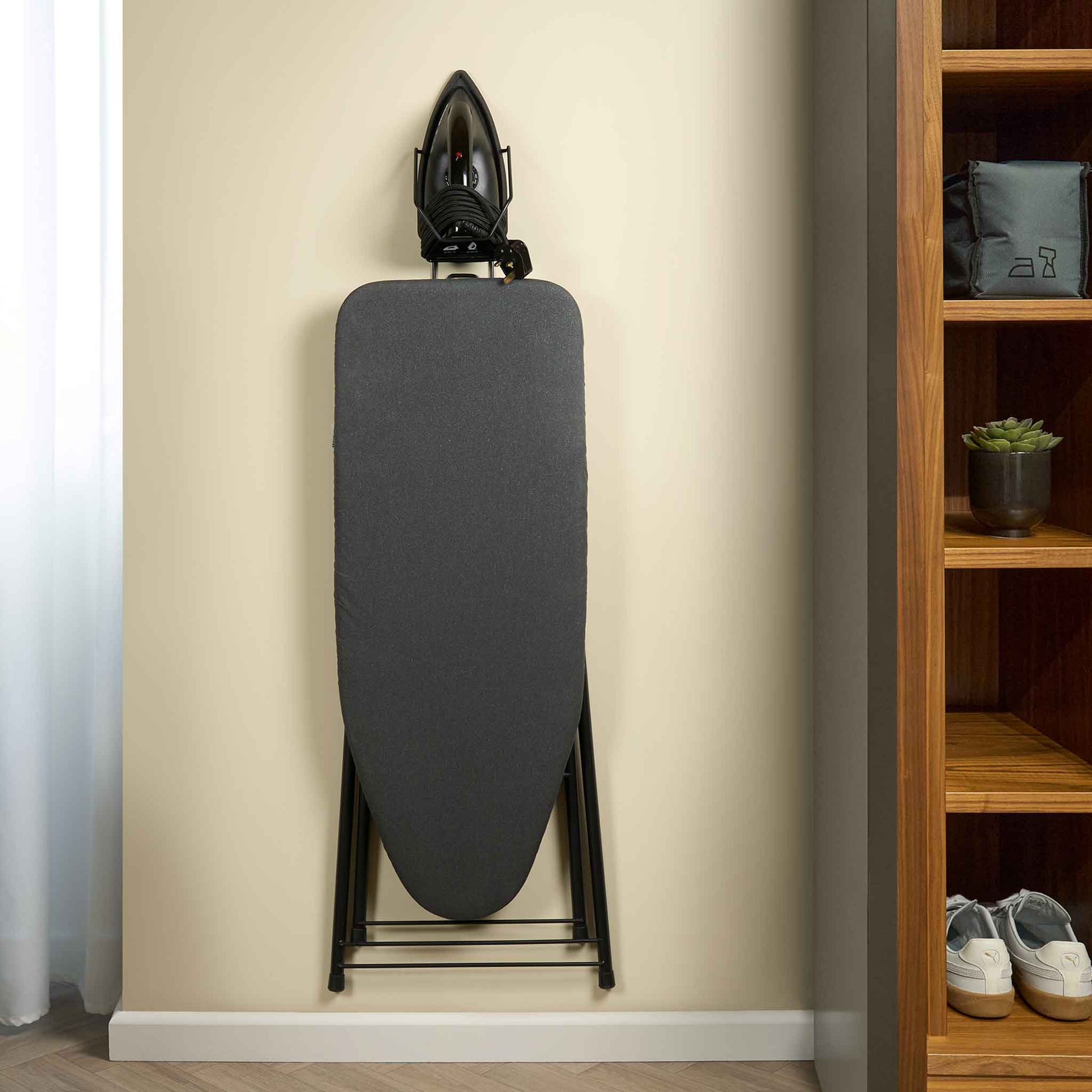 Corby Sherwood iron and ironing board holder mounted on hotel room wall, securely storing dark grey board and black 1200W iron