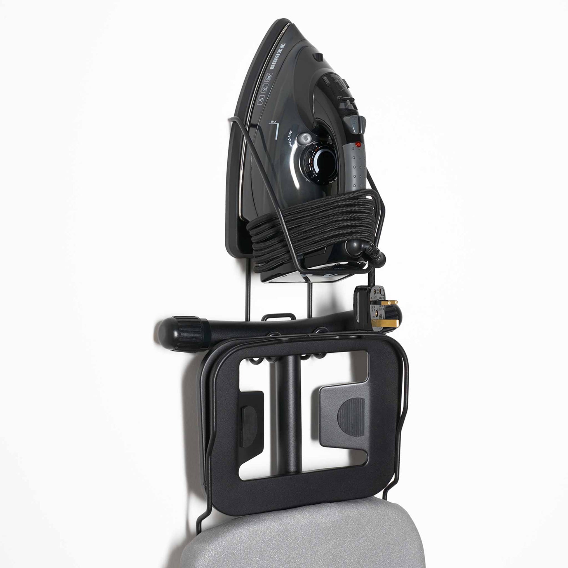 Corby Sherwood wall-mounted holder with 2000W black steam iron and foldable ironing board neatly stored in guest room