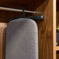 Corby Sherwood ironing board hanger securing dark grey ironing board on wardrobe rail in hotel guest room