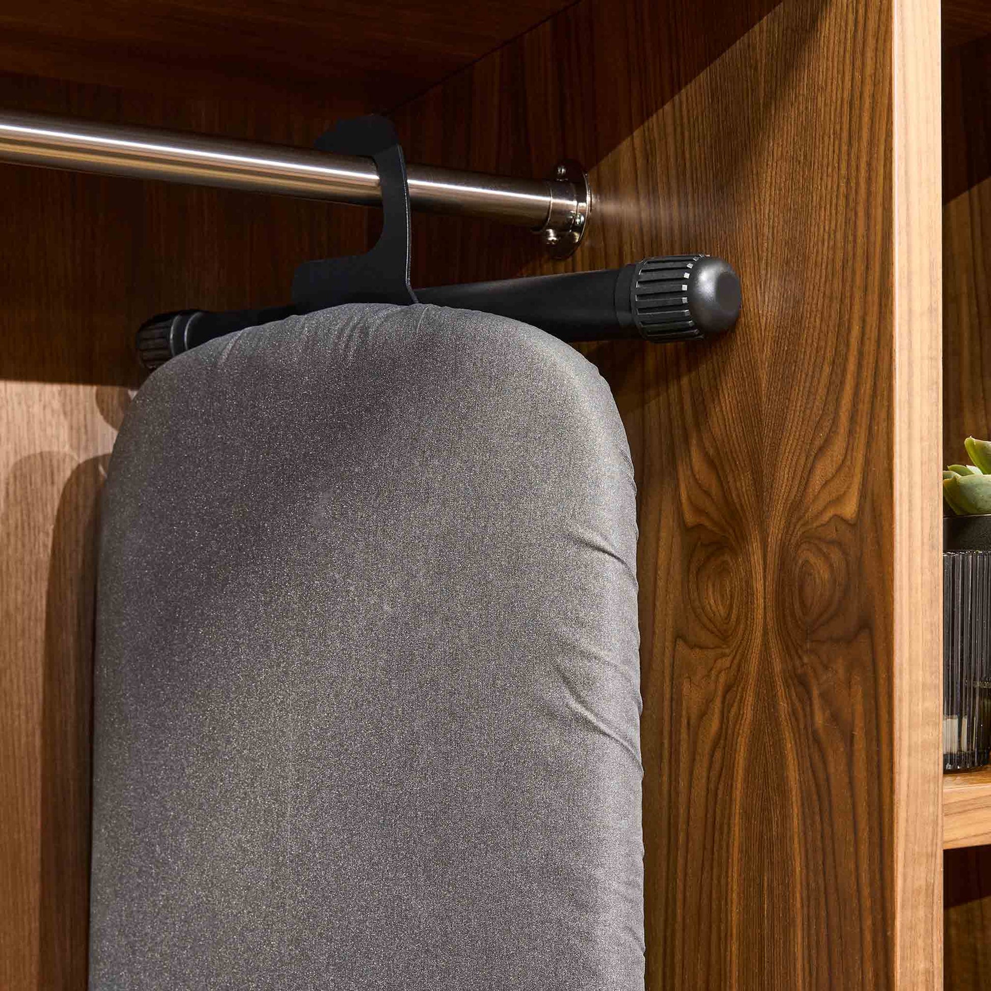 Corby Sherwood ironing board hanger securing dark grey ironing board on wardrobe rail in hotel guest room