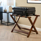 Corby York dark wood folding luggage rack with black suitcase in upscale hotel room setting