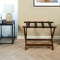 Corby York dark wood luggage rack with black straps in contemporary hotel guest room beside nightstand