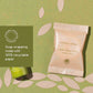 Vegetable soap in a recyclable paper wrapper on a green background with leaf patterns