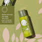Green bottle of Geneva Green conditioner on a green background with leaf patterns