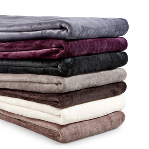 Group of folded thermal blankets in grey, brown, cream, black and maroon