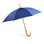 A classic open umbrella with a royal blue canopy and a curved golden-brown wooden handle, shown against a plain white background.