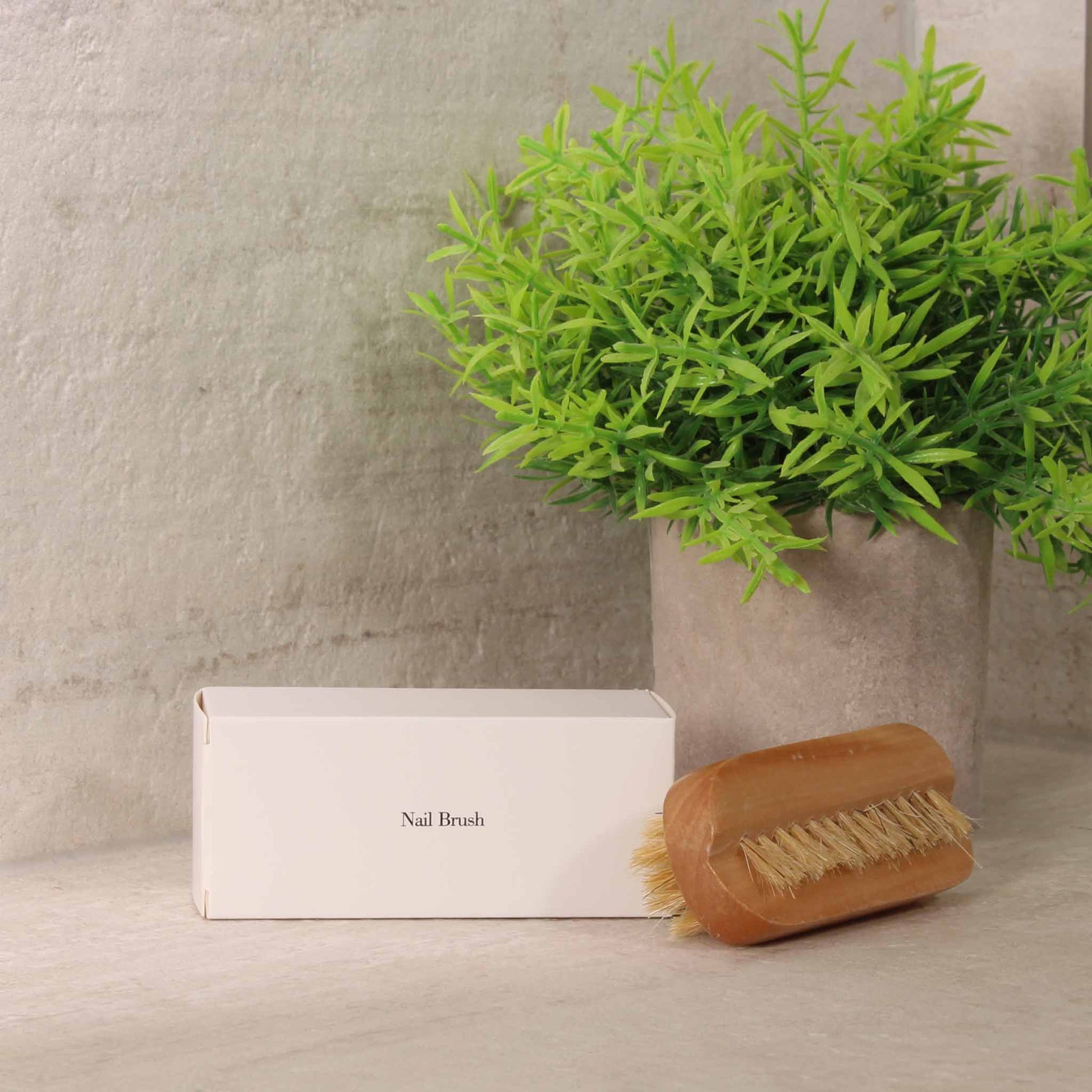 Wooden nail brush and white box lifestyle