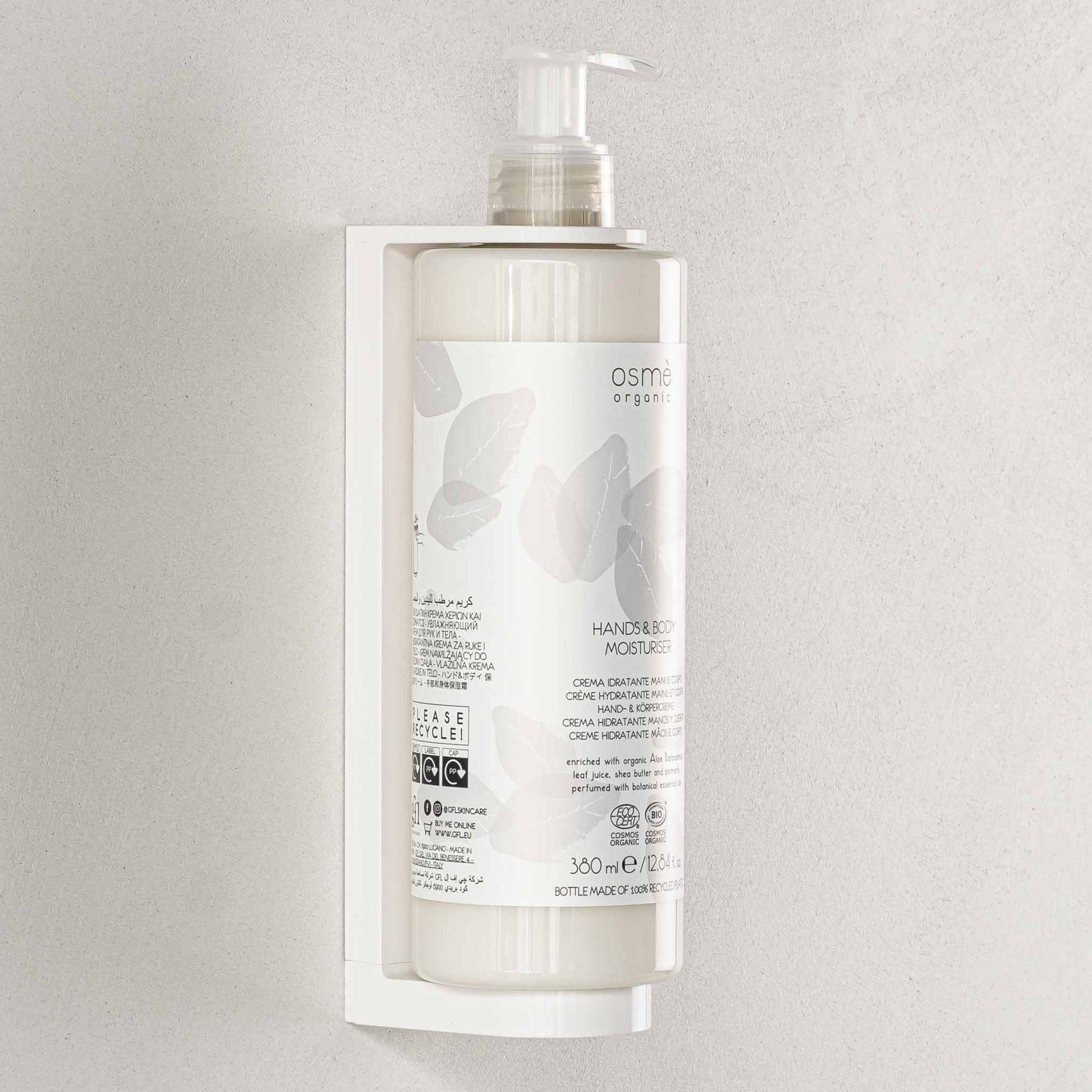 Osme Organic hands and body moisturiser pump dispenser in wall mounted bracket