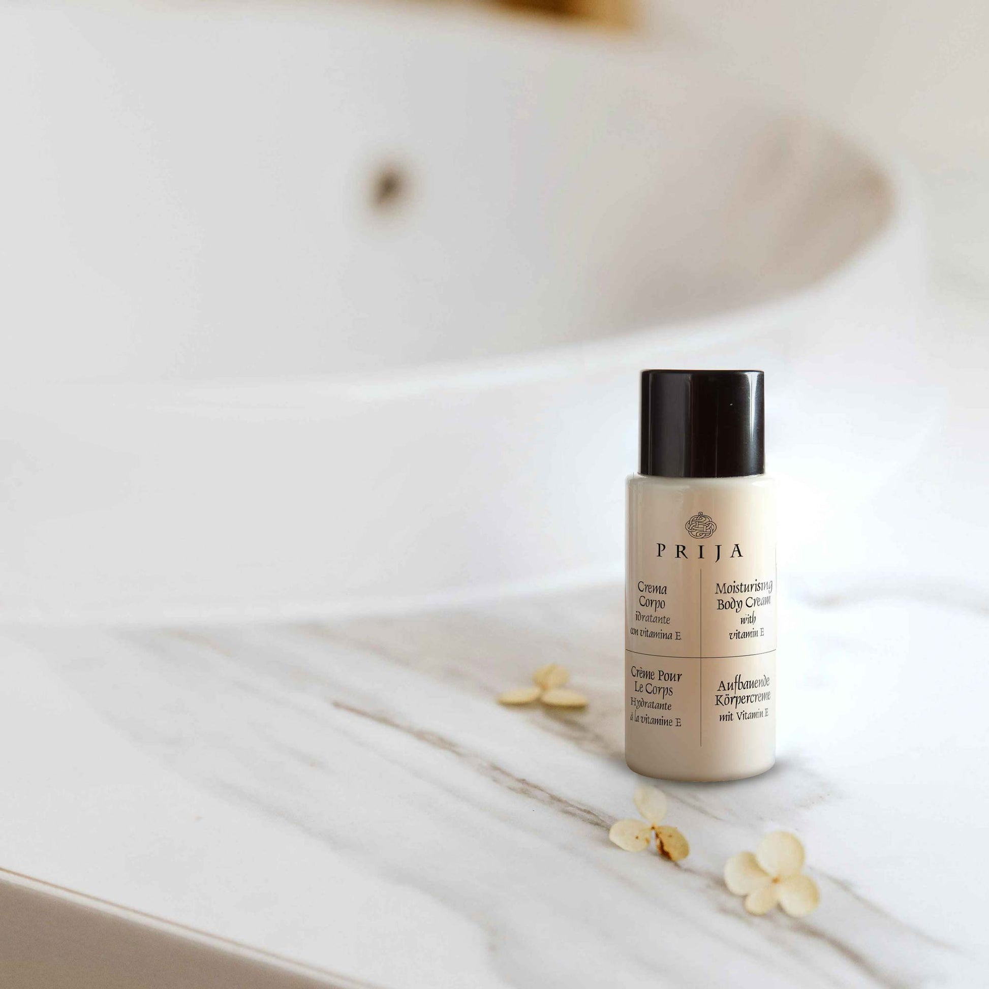 Prija miniature body lotion on a white surface with flowers