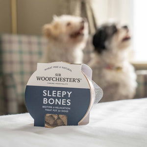Image of sleepy bones dog treats on hotel bed