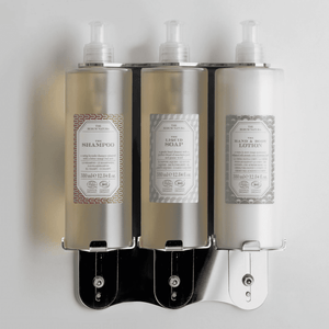 Triple pump dispenser bracket in stainless steel with Rerum Natura soap bottles