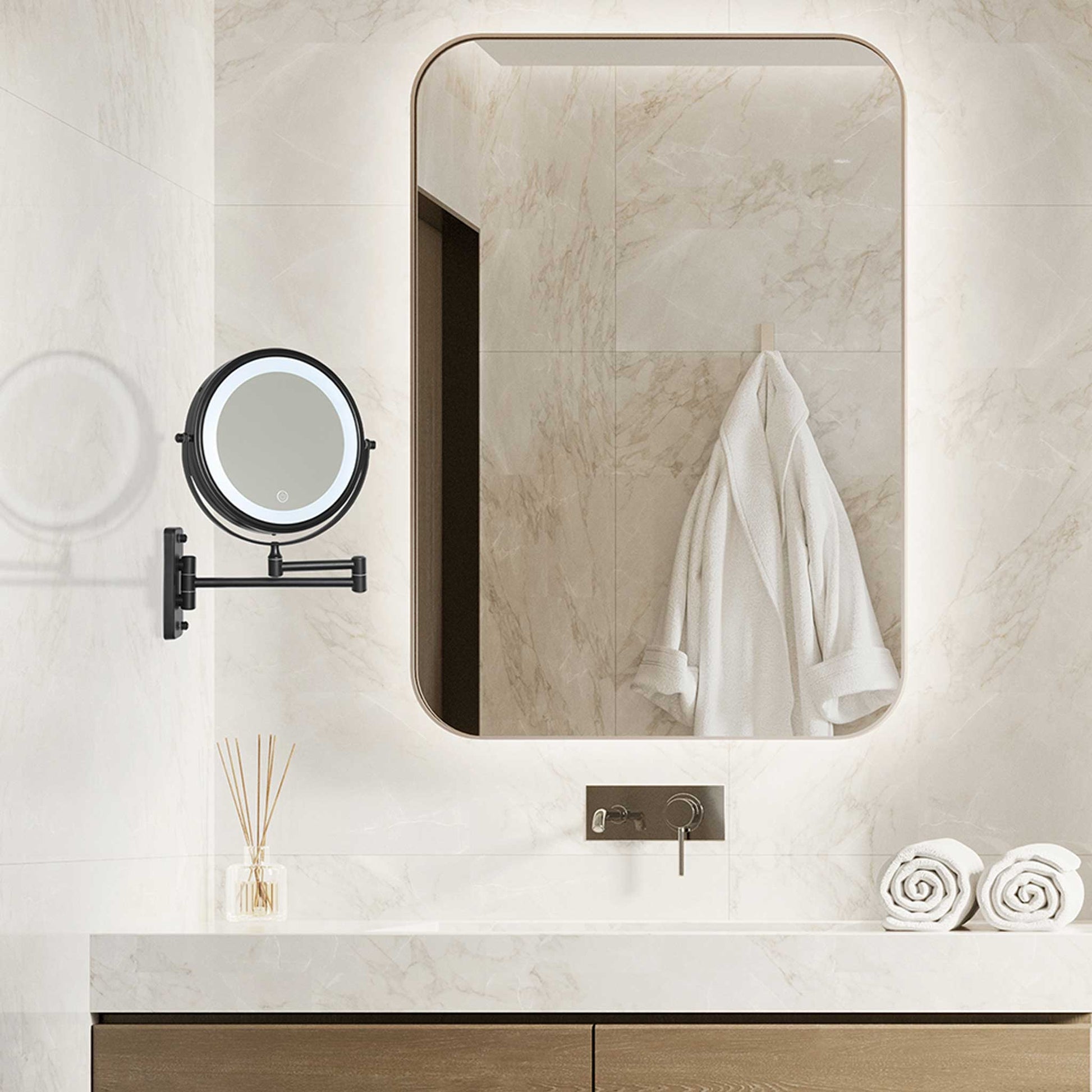 Corby Winchester wall-mounted LED vanity mirror in matt black installed in luxury hotel bathroom with marble tiles and illuminated main mirror