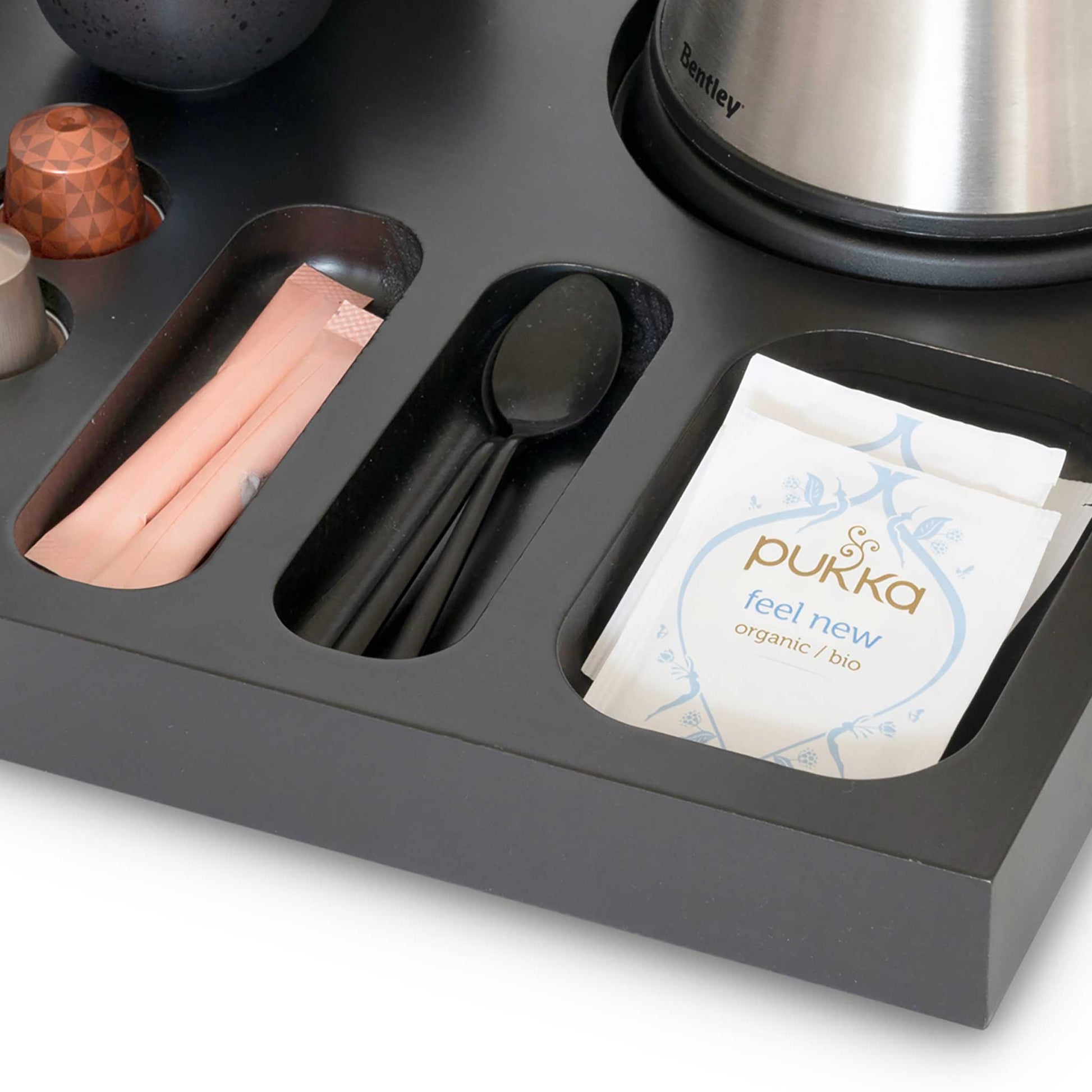 Spoon and tea sachet storage on xanthic coffee and tea wooden hospitality tray